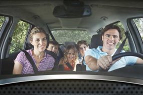 A happy family in a vehicle